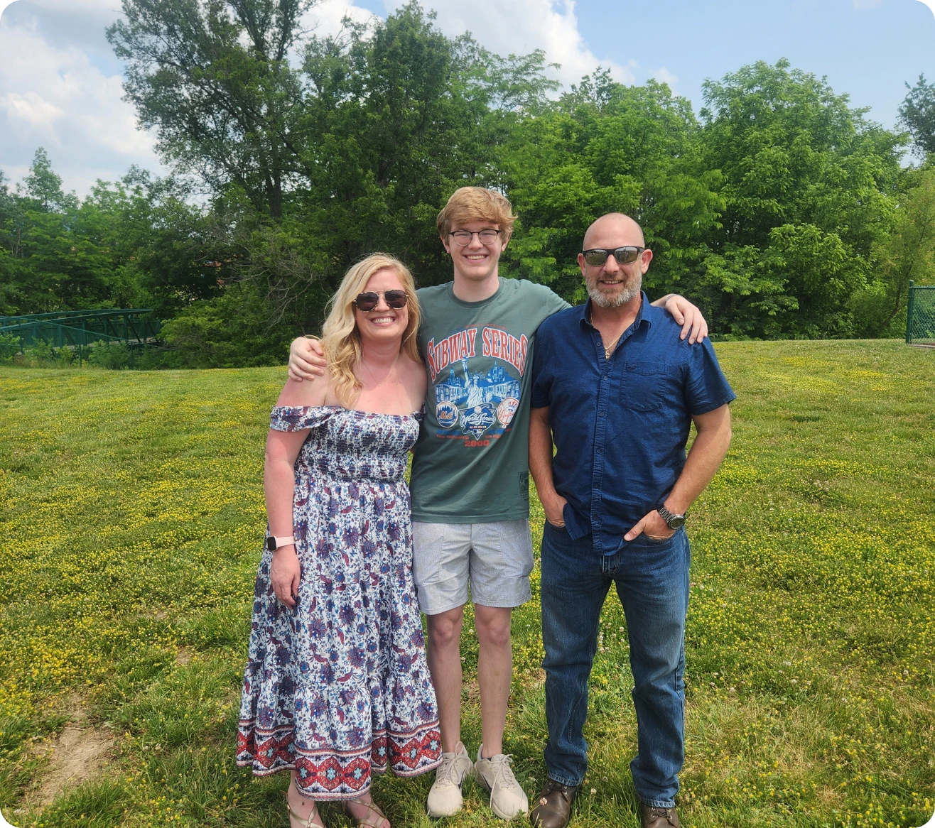 Family posing outdoors on a sunny day