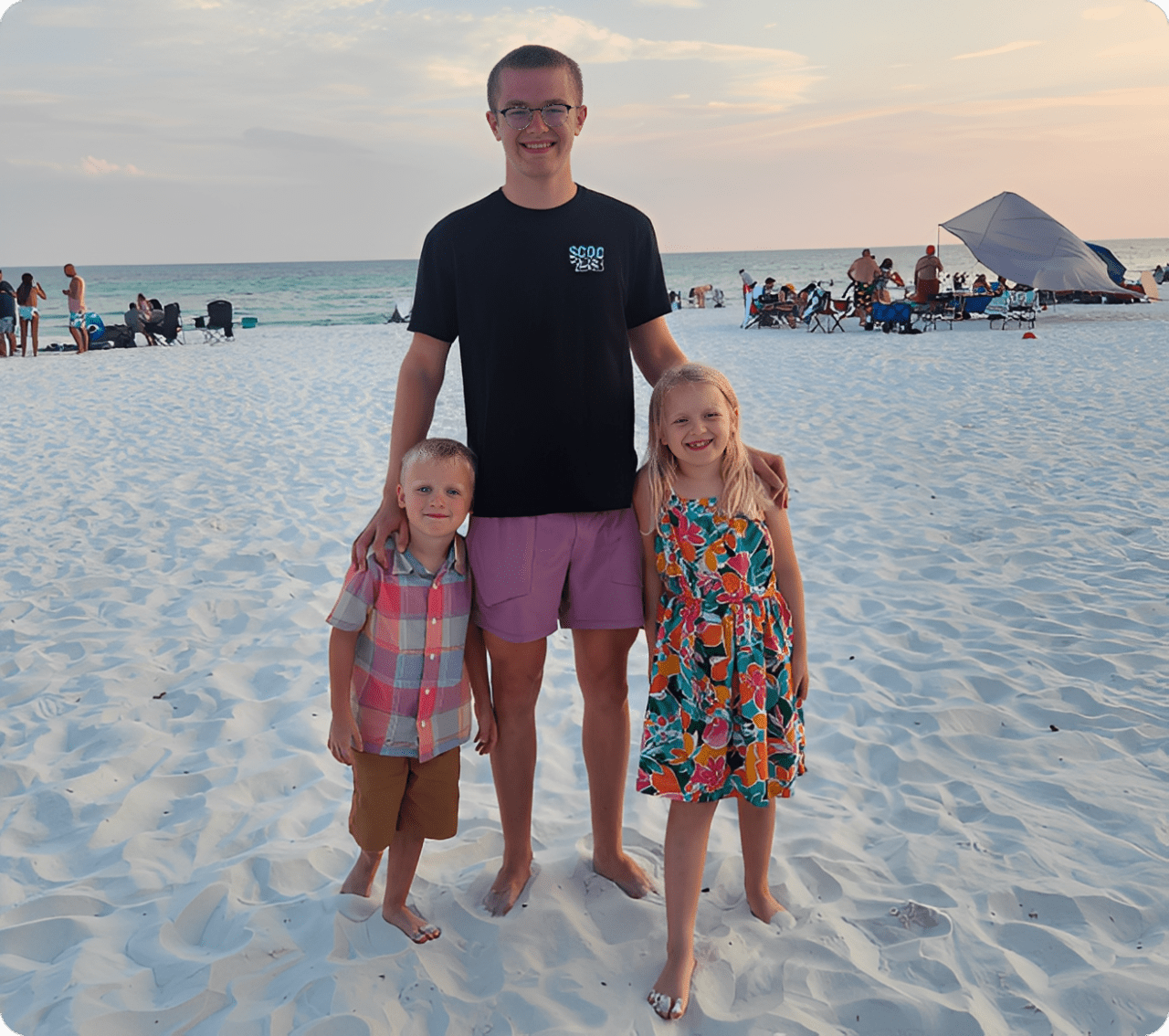 Smiling trio posing on the beach
