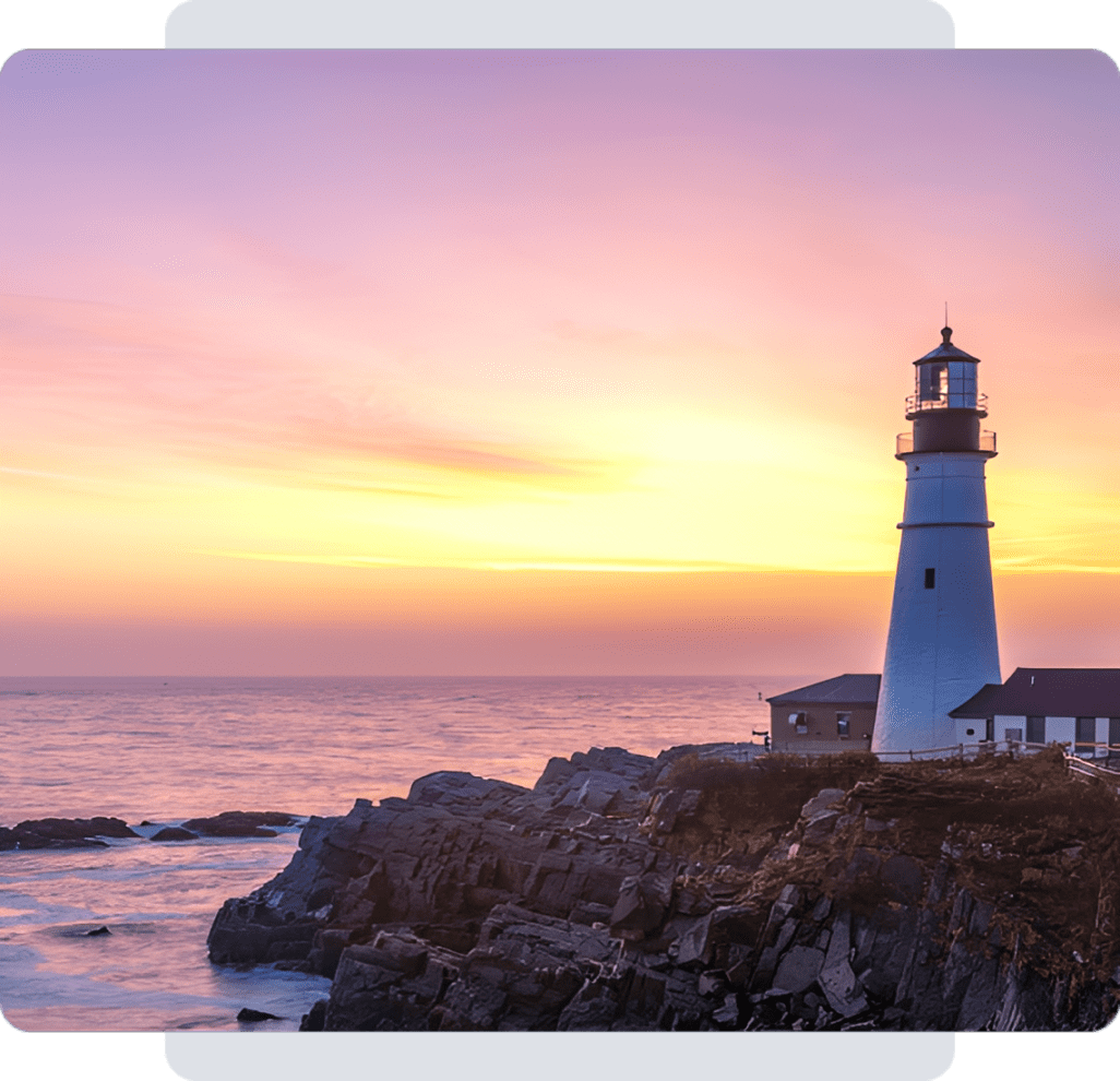 Seaside lighthouse under colorful evening sky
